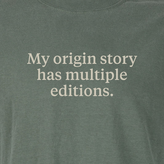 My origin story has multiple editions. | T-shirt
